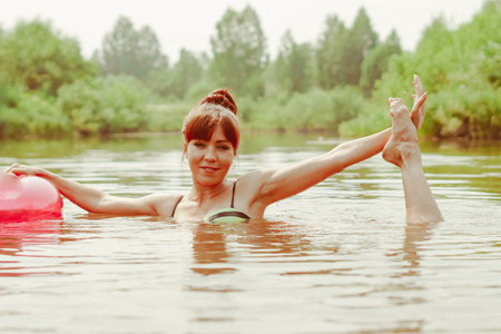 a girl poses standing in the riverの写真素材