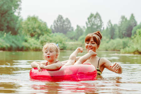 mother and daughter bathe in the riverの写真素材