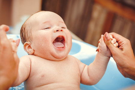 baby boy bathed in the outdoor tubの写真素材