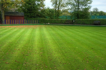 Bowling green during Auttumn Fall with leaves on striped mown lawnの写真素材