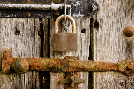 Close up of new padlock with rusted old boltの写真素材