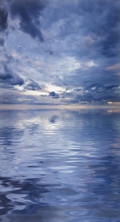 Stunning image of landscape reflected in water with beautiful skyの写真素材
