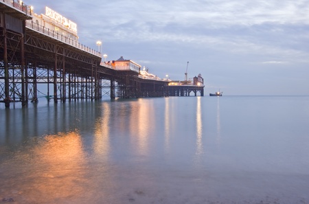Brighton England pier with beautiful sunset in Winter and lights reflected in seaの写真素材