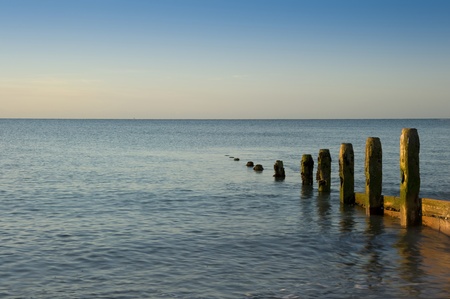 Beautiful long exposure sunrise over beach and vibrant skyの写真素材