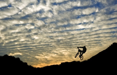 Extreme sports bike trials silhouette against beautiful sunsetの写真素材