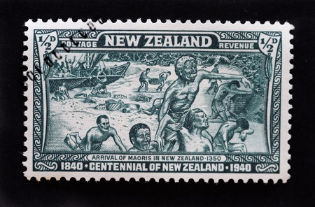 NEW ZEALAND - CIRCA 1940 - Postage stamp showing maoris arriving to New Zealand in 1350 commemorating the centennial of the countryの写真素材