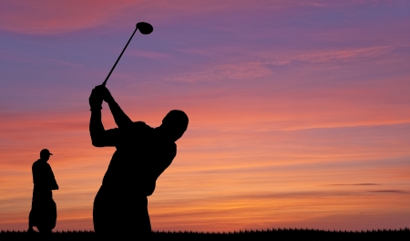 Golfer silhouette on beautiful colorful sunset evening skyの写真素材
