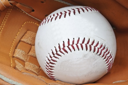 Macro shot of baseball in glove with shallow depth of field for attention on ballの写真素材