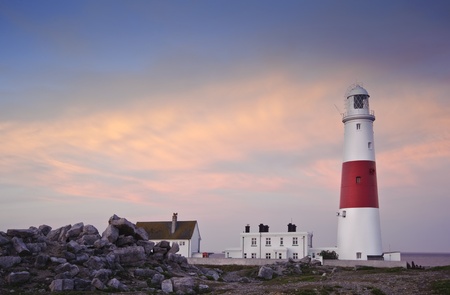 Old lighthouse is bathed in sunlight during beautiful sunset in Summerの写真素材