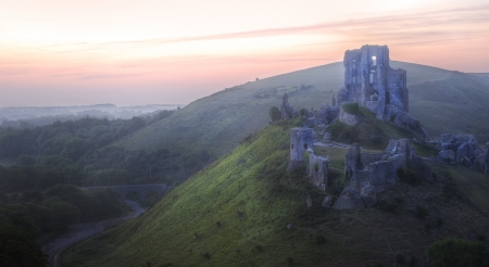 Beautiful dreamy fairytale castle ruins against romantic colorful sunriseの写真素材