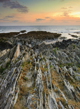 Beautiful sunset with detailed colorful rock formations in foregroundの写真素材