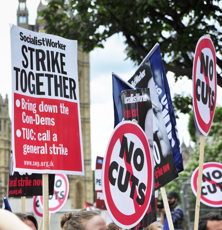 LONDON - JUNE 30; Various placards displayed during a protest against proposed government spending...