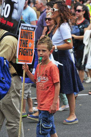 LONDON - JUNE 30; An unidentified child joins the protest against proposed government cuts and pension reform during a demonstration  organised by NUT and PCS trade unions in London on June 30, 2011のeditorial素材