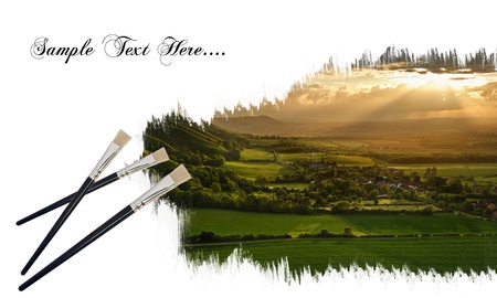 Creative concept image of new paintbrushes painting beautiful landscape onto paperの写真素材