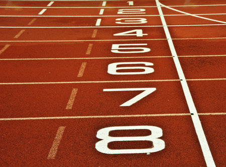 Close up of athletics running track start and finish line with numbers from 1 to 8のeditorial素材