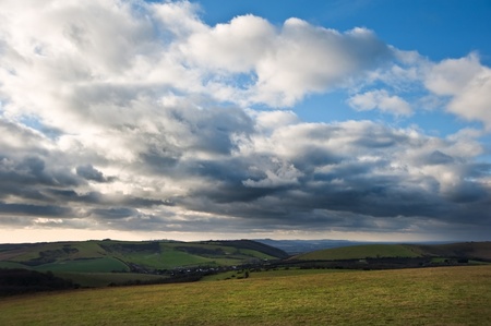 Stunning cloud formations during stormy sky over countryside landscape with vibrant colorsの写真素材