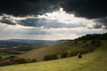 Sunset beams of lighht on hils in countryside landscape in Springの写真素材