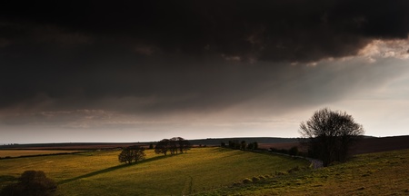Beautiful landscape over agricultural fields with moody sky and invigorating sunlightの写真素材