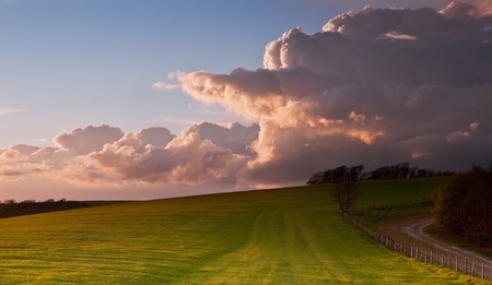 Beautiful landscape over agricultural fields with moody sky and invigorating sunlight