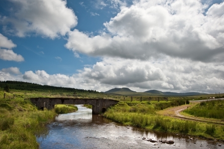 Beautiful landscape across countryside to mountains in distance with moody skyの写真素材