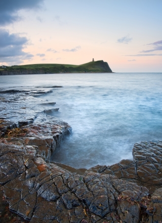 Beautiful sunrise landscape image at Kimmeridge Bay on Jurassic Coast, Dorset, Englandの写真素材