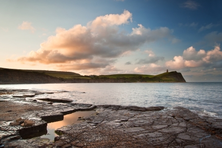 Beautiful sunrise landscape image at Kimmeridge Bay on Jurassic Coast, Dorset, Englandの写真素材