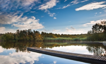 Beautiful sunsey sky reflected in Autumn Fall lakeの写真素材