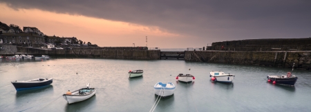 Fishing boats in harbour at sunrise long exposure imageの写真素材
