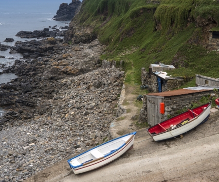 Fishing boats and huts on slipway on shoreの写真素材