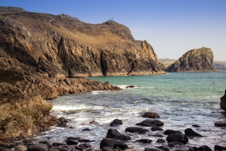 Kynance Cove beach with people on rocksの写真素材
