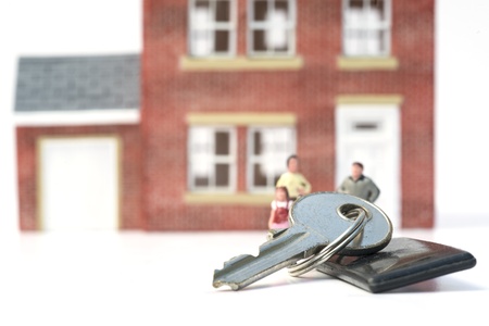 Family home concept with model house and people on white backgroundの写真素材