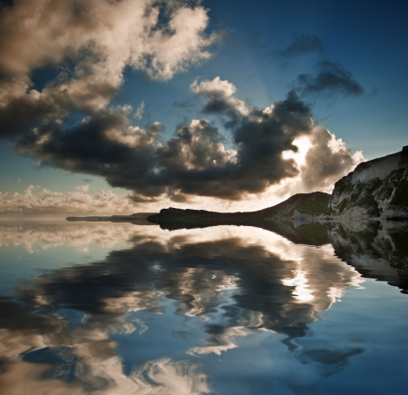 Beautiful sunrise landscape over Mupe Bay on Jurassic Coast in Dorset, Englandの写真素材