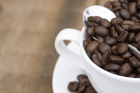 Cup of coffee and beans on wooden backgroundの写真素材