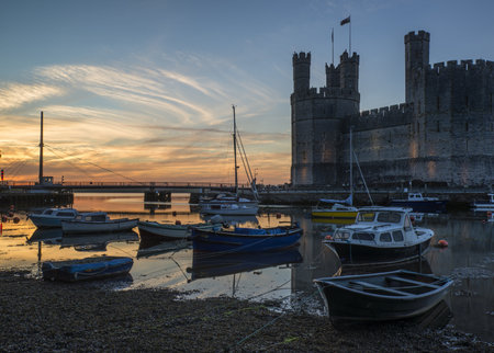 CAERNARVON CASTLE, WALES - JUNE 18: 13th Century Caernarvon Castle in Wales on June 18th, 2013 is one of the most visited tourist attractions in Wales seen here at the start of the tourism seasonのeditorial素材