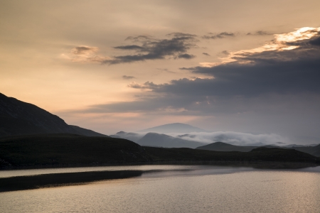 Beautiful sunrise reflected in calm Cregennen Lakes in Snowdonia National Parkの写真素材