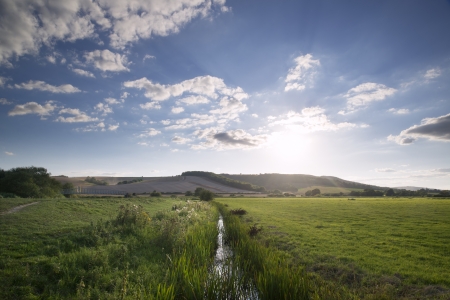Small stream flowing through countryside landscape on Summer dayの写真素材