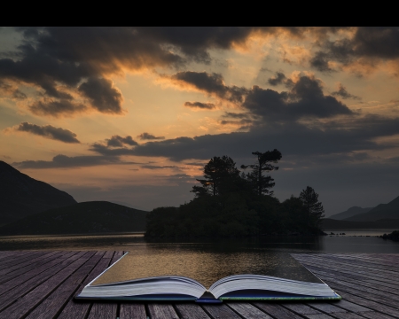 Creative concept pages of book Beautiful sunrise reflected in calm Cregennen Lakes in Snowdonia National Park landscape with sunbeamsの写真素材
