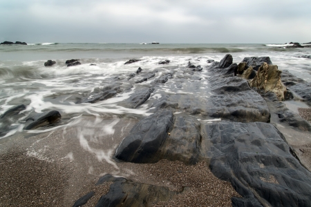 Rugged long exposure landscape seascape of rocky coastline