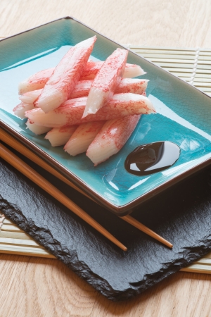 Raw fresh sushi carbsticks on plate with chopsticksの写真素材