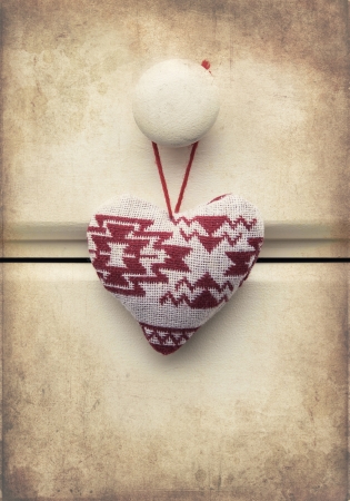Macro retro cross processed effect image of hand made Christmas heart on wooden backgroundの写真素材