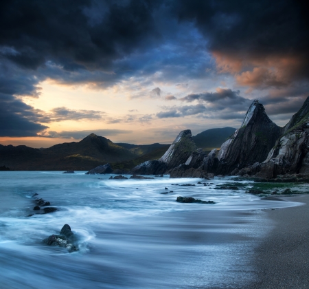 Stunning mountain and sea sunset landscape の写真素材