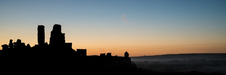 Panorama landscape medieval castle silhouette vibrant dawn sunriseの写真素材