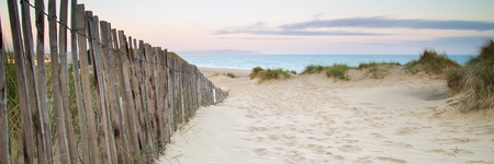 Panorama landscape of sand dunes system on beach at sunriseの写真素材