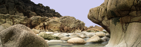 Panorama landscape of rocky coastline at sunrise
