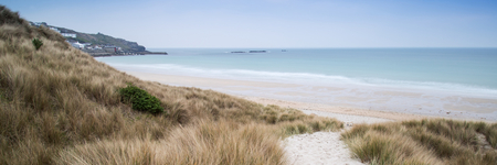 Panorama landscape across grassy sand dunes on beach