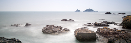 Panorama landscape of rocky coastline at sunrise