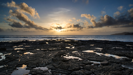 Stunning landscape ocean at sunset dramatic clouds