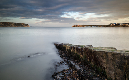 Long exposure seascape landscape during dramatic evening sunsetの写真素材