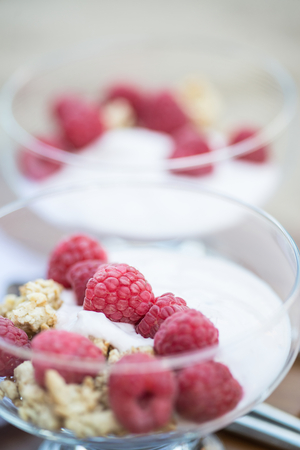 Breakfast of fresh raspberries and yoghurtの写真素材