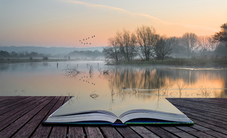 Book concept Beautiful tranquil landscape of lake in mistの写真素材